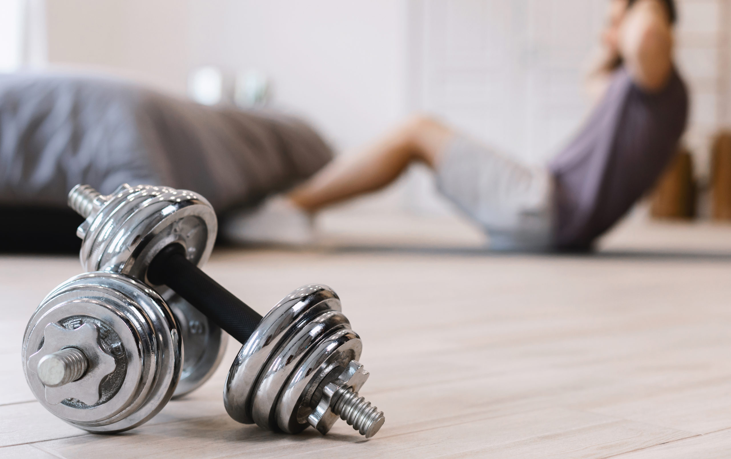 Unrecognizable Guy Doing Abs Exercise Training At Home, Shallow Depth